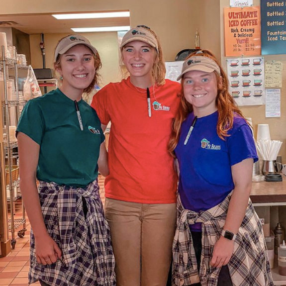 Three smiling Mr. Beans team members behind the counter